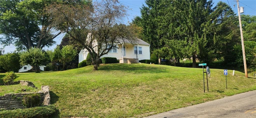 1677 Mercer Road Ellwood City, PA 16117 - Photo 4 of 22 a yellow house with a yard