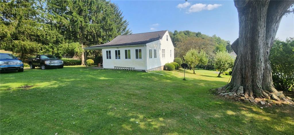 1677 Mercer Road Ellwood City, PA 16117 - Photo 6 of 22 a front view of a house with a garden