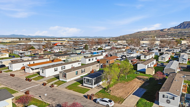 2491 Highway 89, Unit 523 Pleasant View, UT 84404 - Photo 30 of 31 Aerial perspective of suburban area featuring a mountainous background