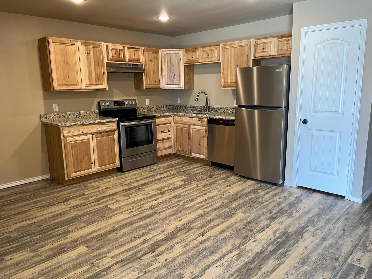 2425 N Avenue North Lubbock, TX 79403 - Photo 2 of 9 a kitchen with white cabinets and stainless steel appliances