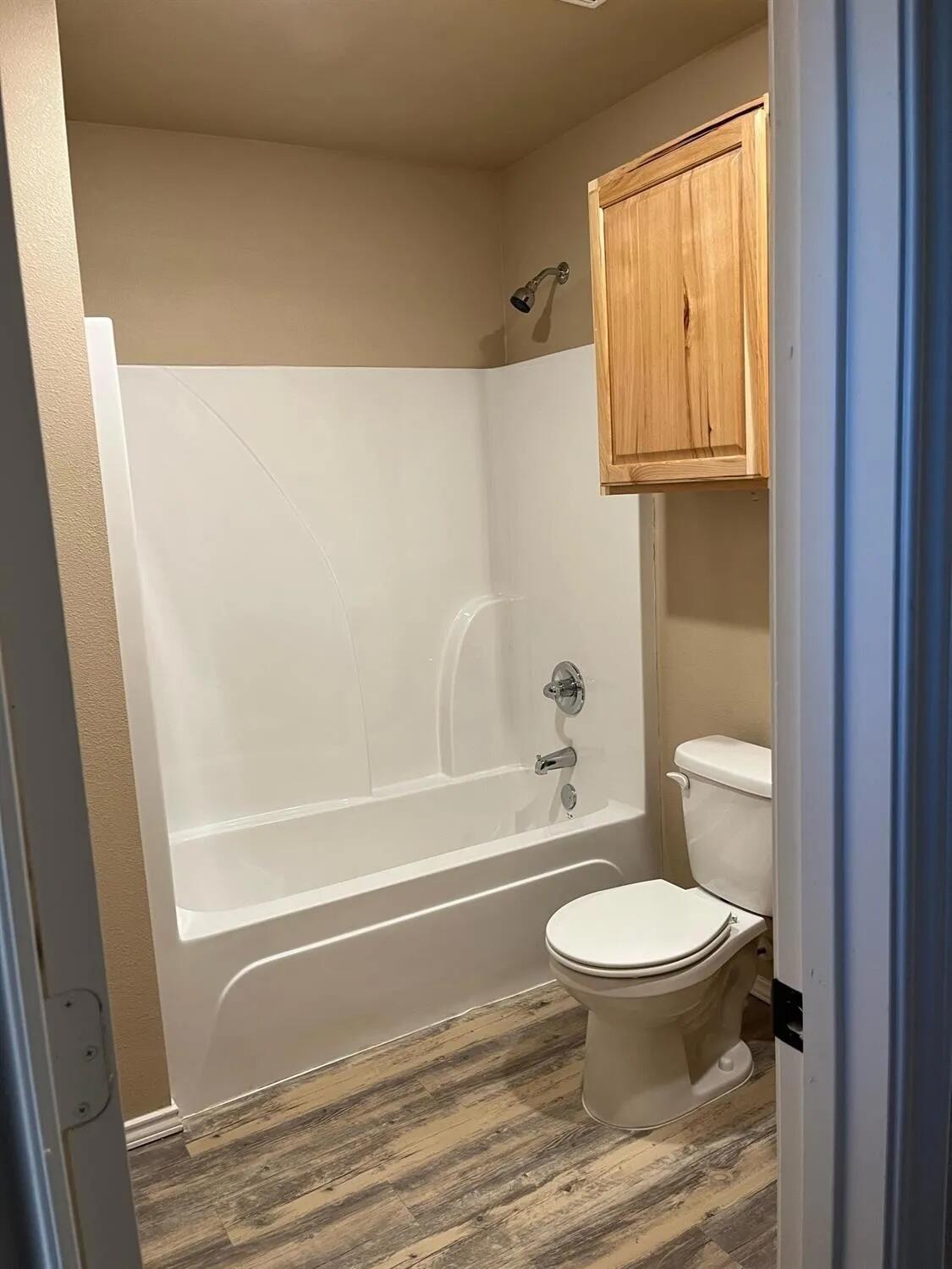 2425 N Avenue North Lubbock, TX 79403 - Photo 6 of 9 a bathroom with a toilet and a shower