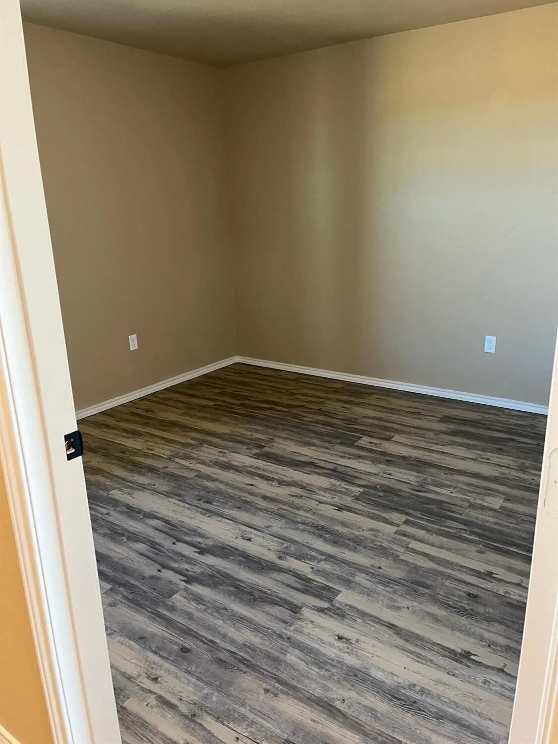 2425 N Avenue North Lubbock, TX 79403 - Photo 7 of 9 a view of empty room with wooden floor
