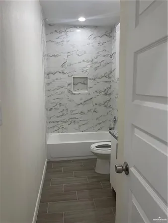 a bathroom with a toilet and a shower