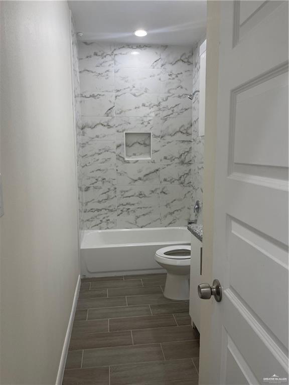 405 Rafael Drive, Unit 2 San Juan, TX 78589 - Photo 7 of 9 a bathroom with a toilet and a shower