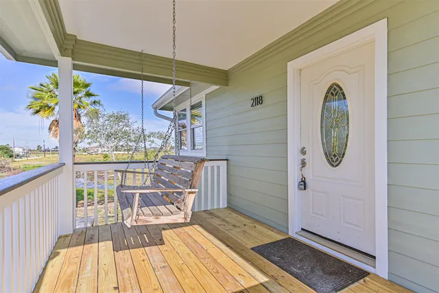 a view of a balcony with wooden floor