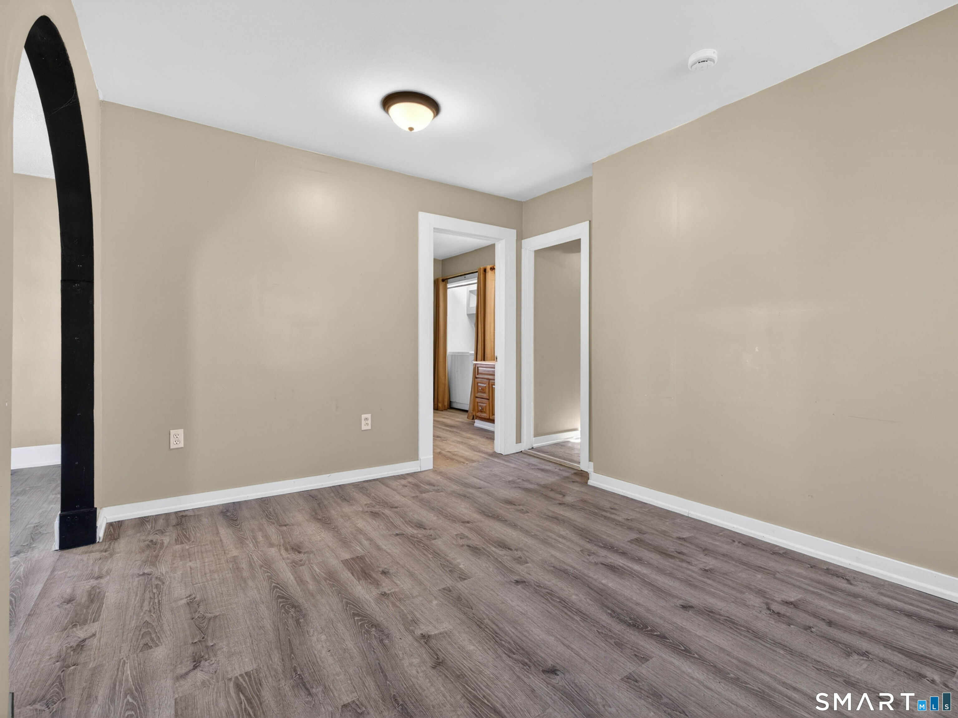 97 Woodland Street Meriden, CT 06451 - Photo 12 of 35 an empty room with wooden floor and windows