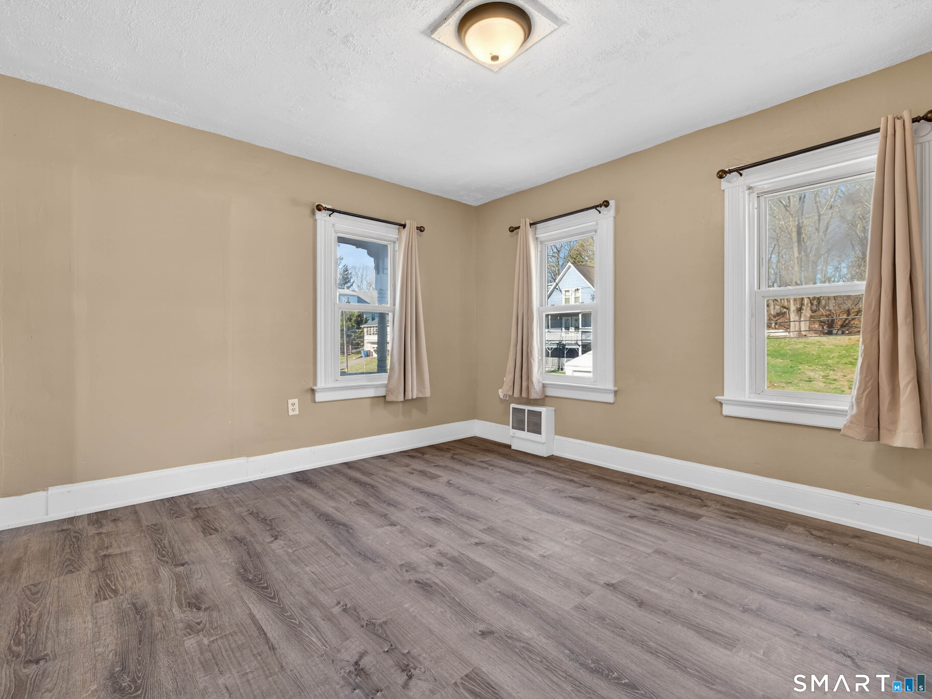 97 Woodland Street Meriden, CT 06451 - Photo 15 of 35 a view of an empty room with window and wooden floor