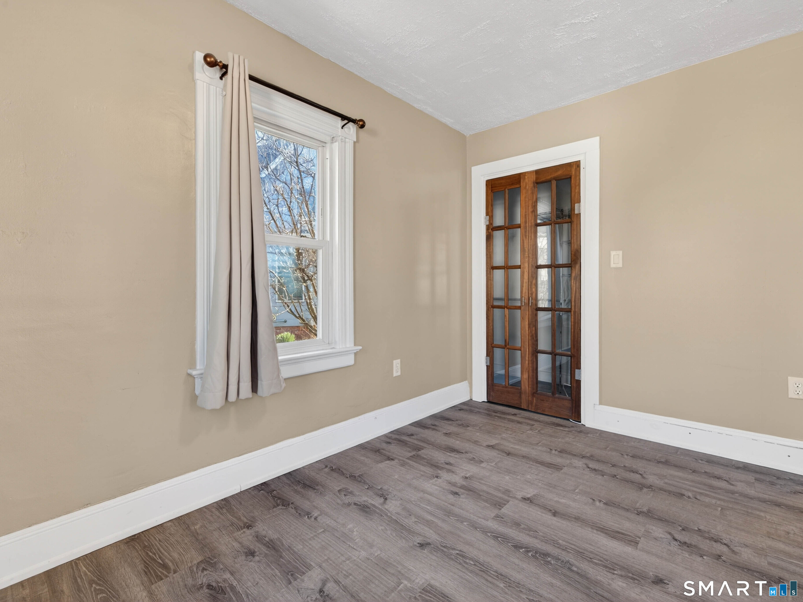 97 Woodland Street Meriden, CT 06451 - Photo 16 of 35 an empty room with wooden floor and windows