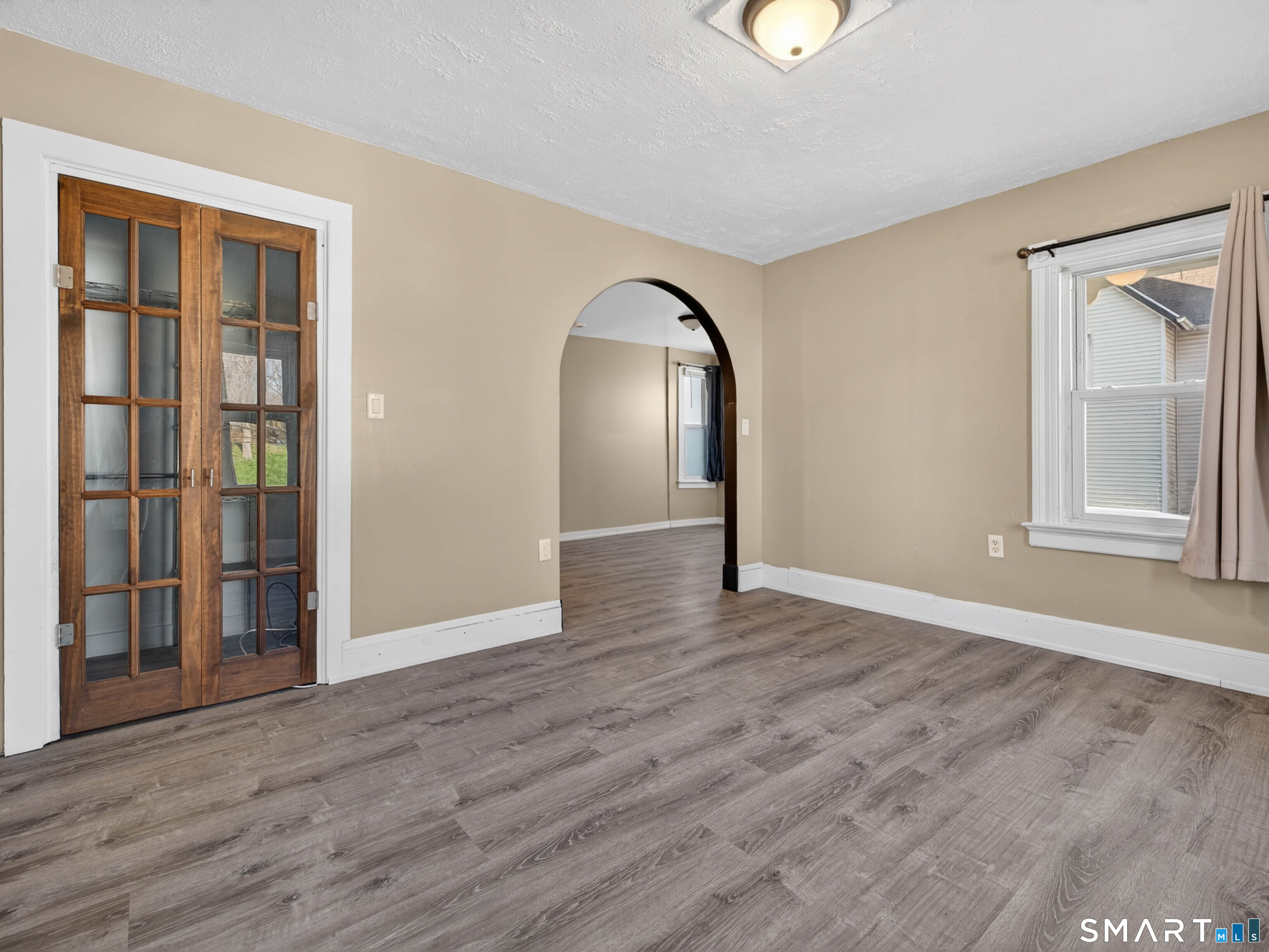 97 Woodland Street Meriden, CT 06451 - Photo 17 of 35 a view of empty room with wooden floor and fan