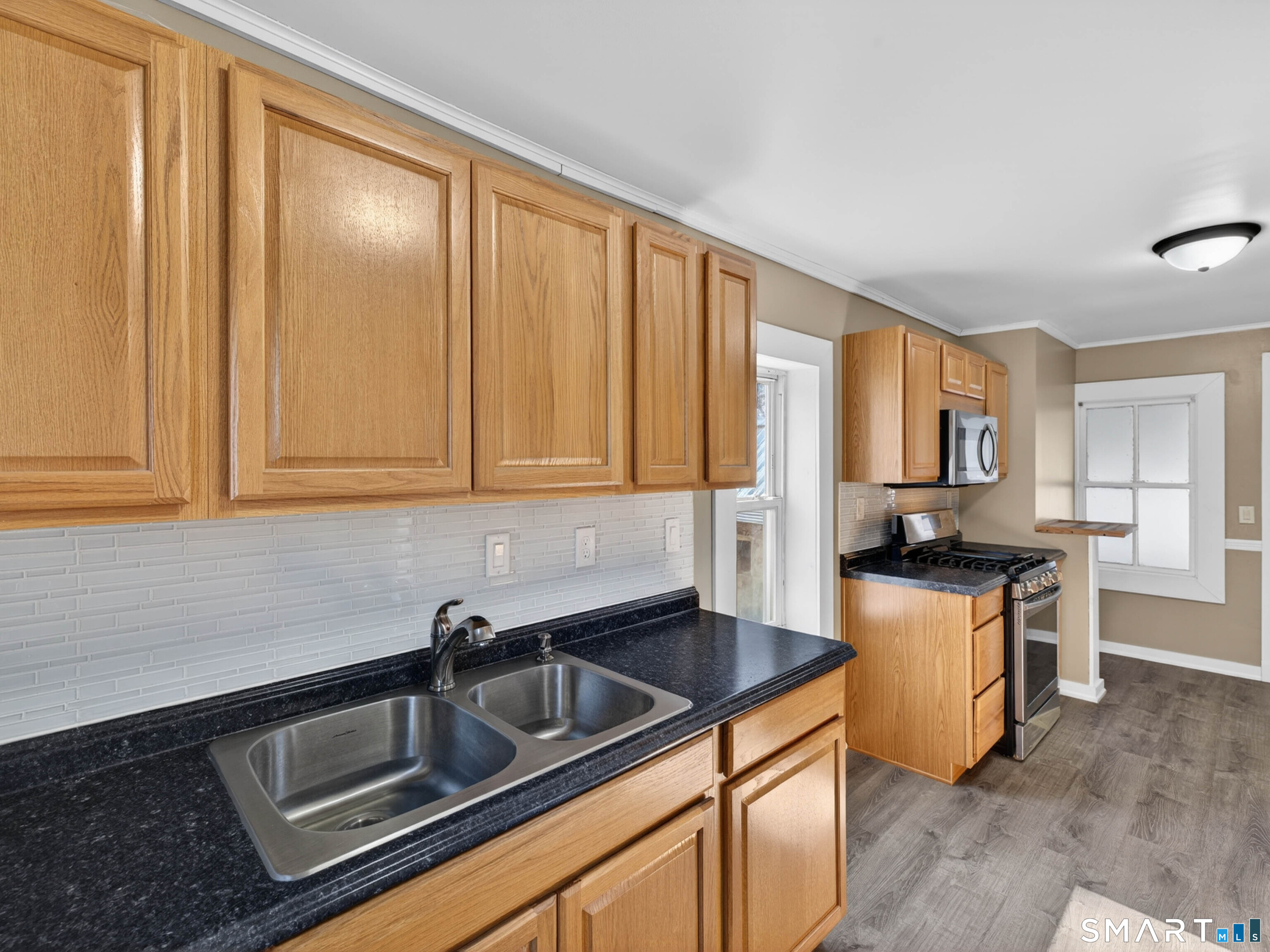 97 Woodland Street Meriden, CT 06451 - Photo 3 of 35 a kitchen with stainless steel appliances granite countertop a sink stove and refrigerator
