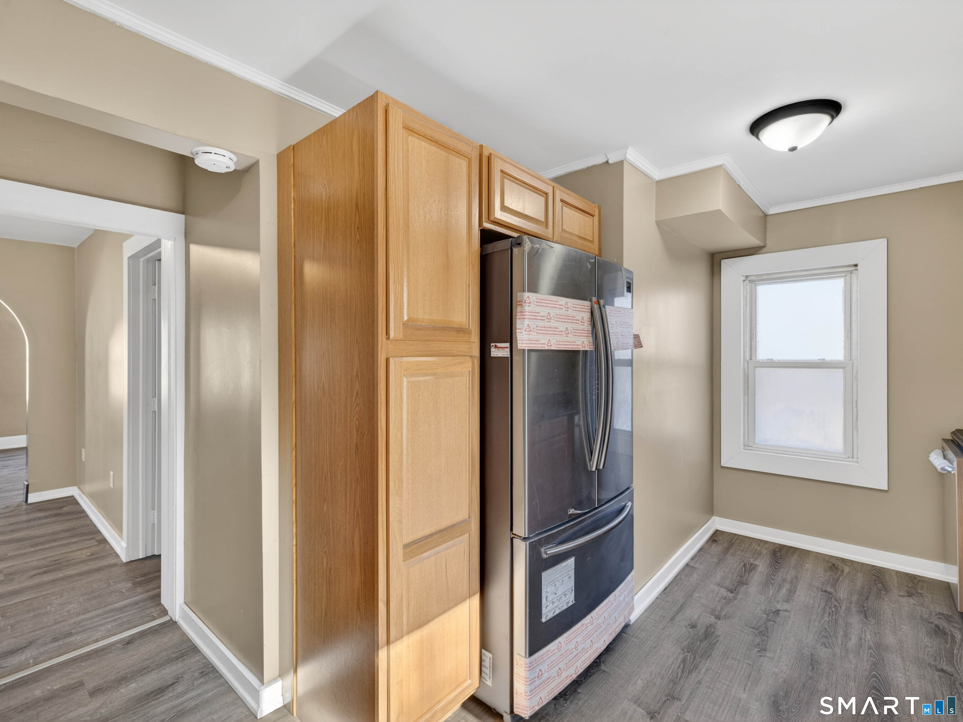 97 Woodland Street Meriden, CT 06451 - Photo 4 of 35 a view of an empty room and wooden floor and a cabinet