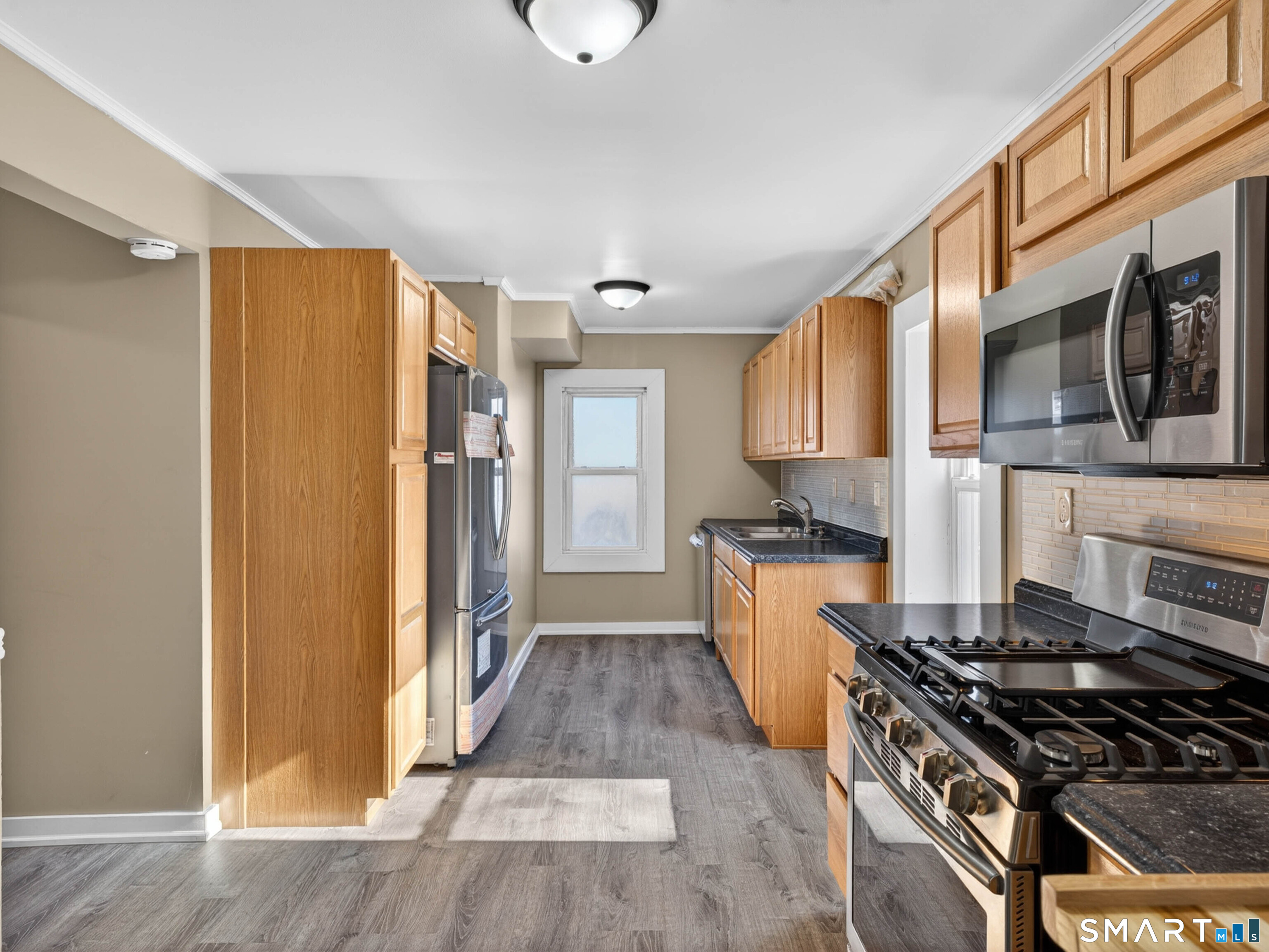 97 Woodland Street Meriden, CT 06451 - Photo 5 of 35 a kitchen with a stove a refrigerator and cabinets