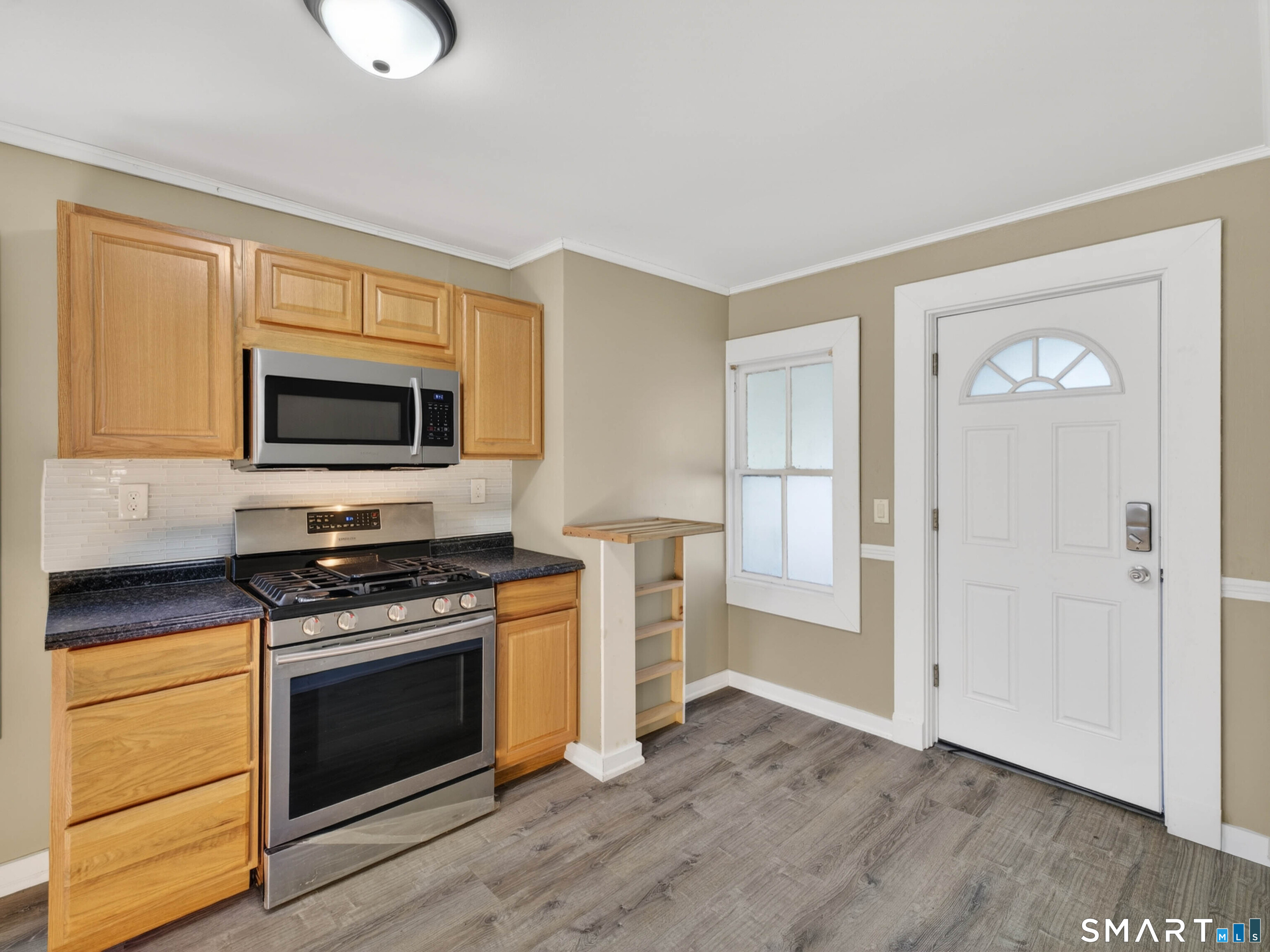 97 Woodland Street Meriden, CT 06451 - Photo 6 of 35 a kitchen with a stove microwave and a refrigerator