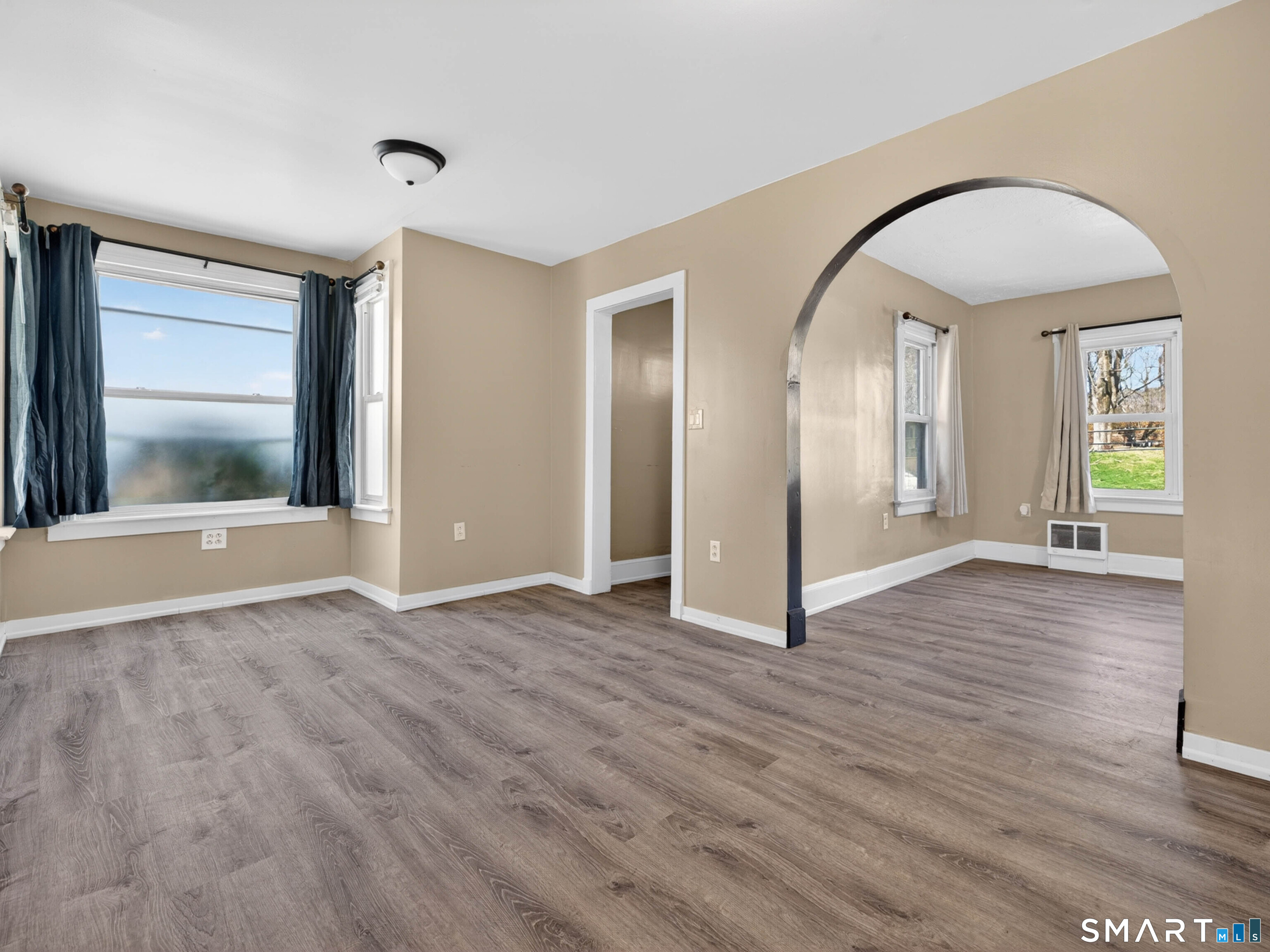 97 Woodland Street Meriden, CT 06451 - Photo 7 of 35 a view of an empty room with window and wooden floor