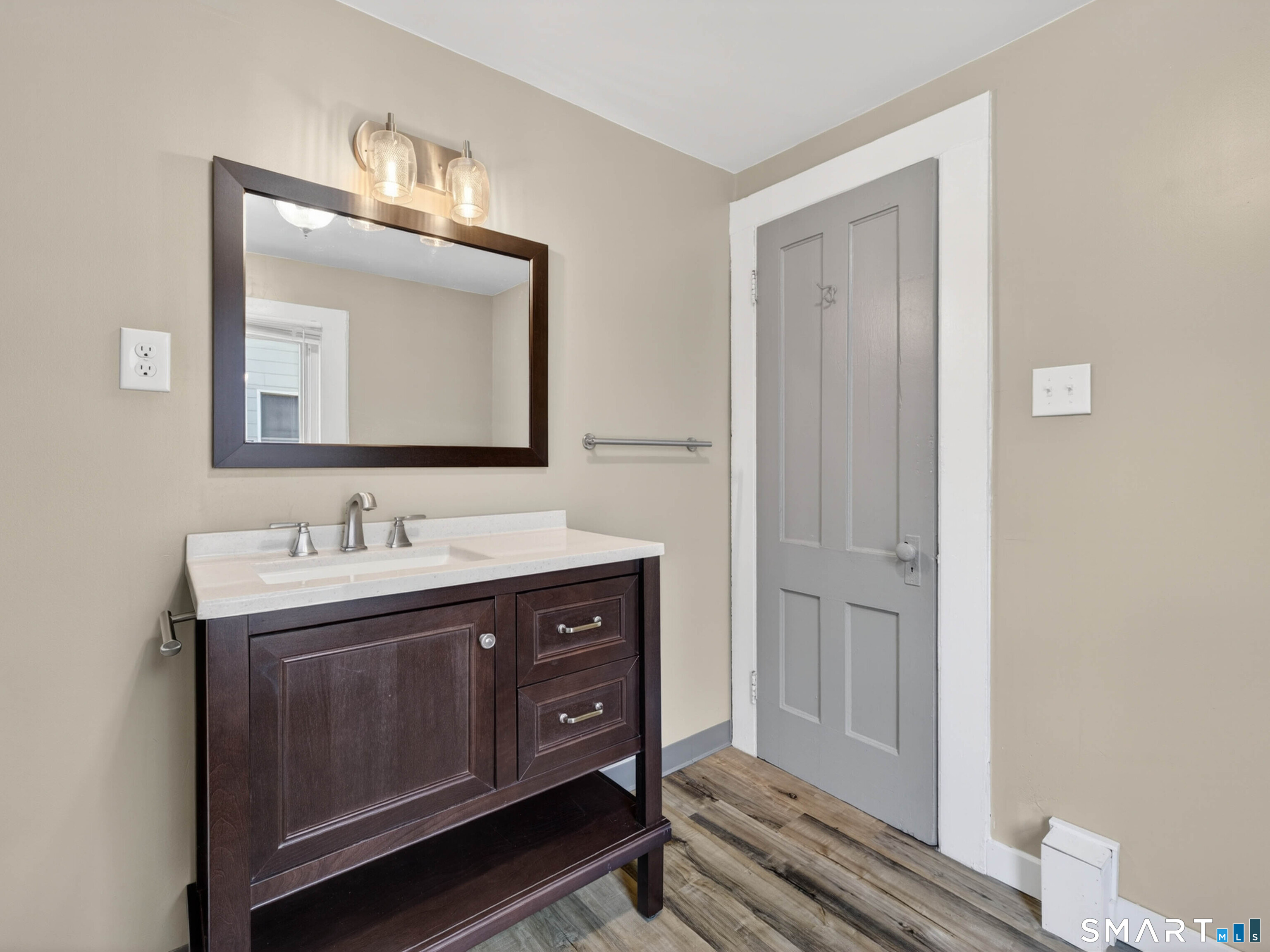 97 Woodland Street Meriden, CT 06451 - Photo 8 of 35 a bathroom with a toilet sink and mirror