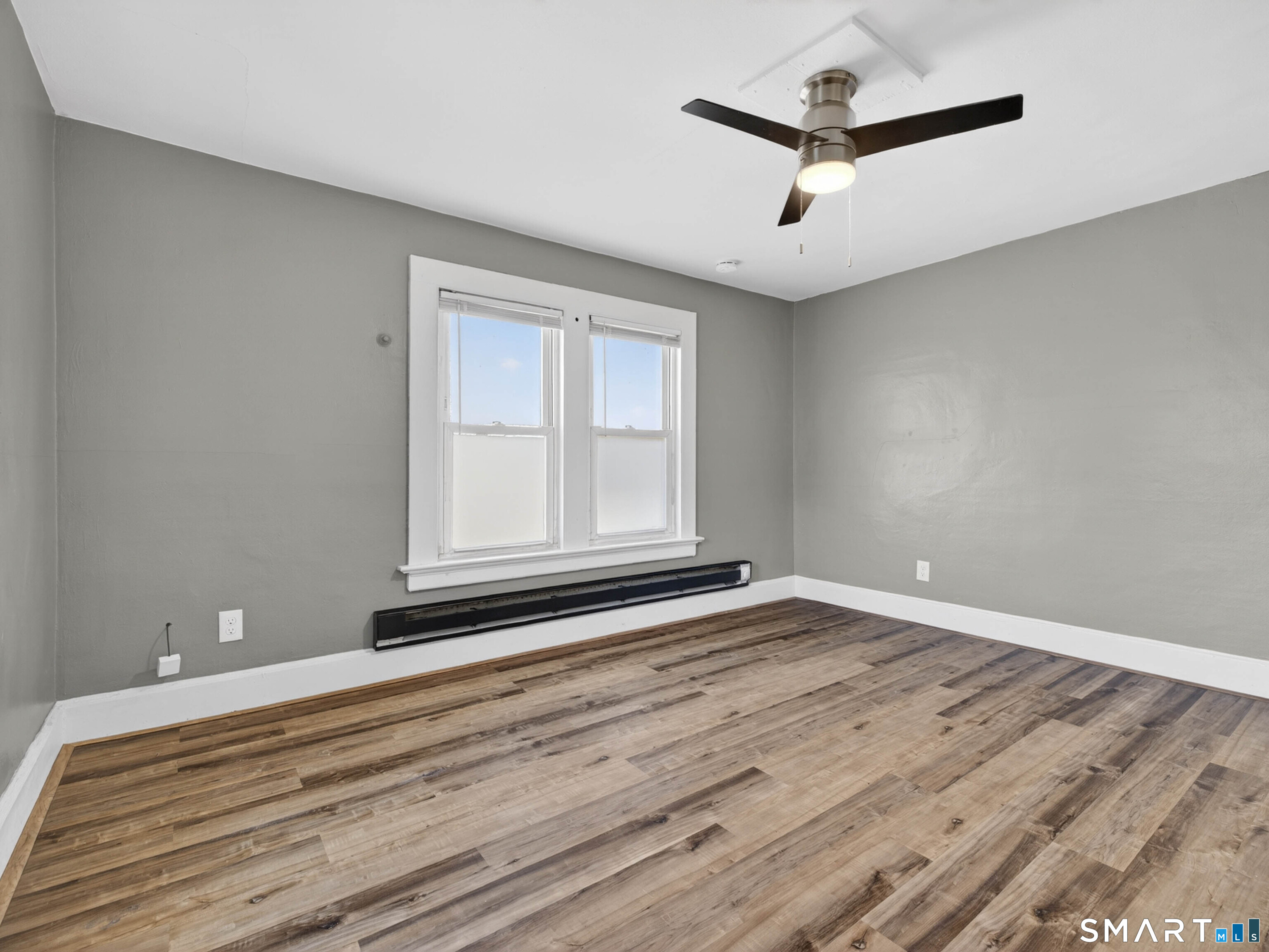 97 Woodland Street Meriden, CT 06451 - Photo 9 of 35 a view of empty room with ceiling fan and window