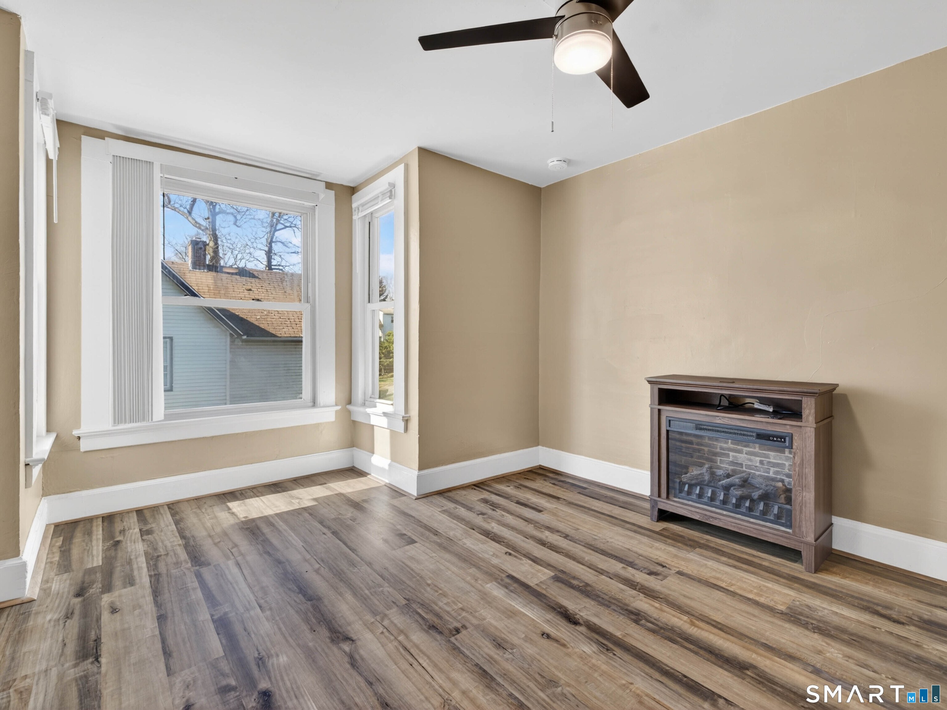 97 Woodland Street Meriden, CT 06451 - Photo 10 of 35 a view of an empty room with a window and wooden floor
