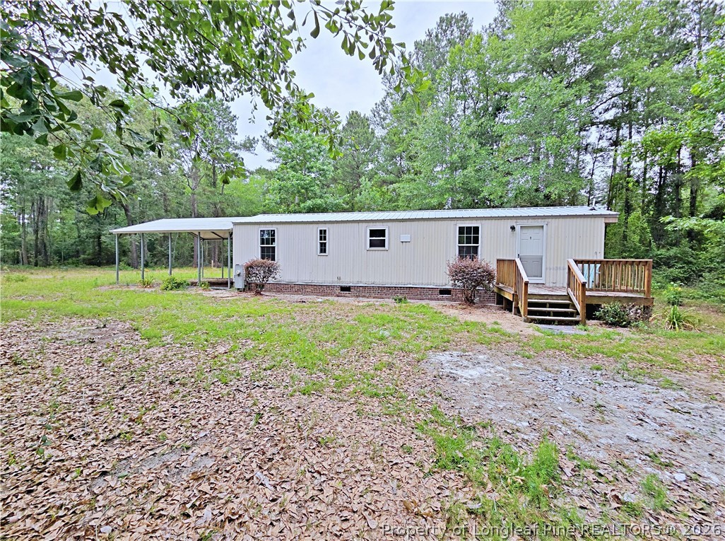 1031 Pine Acres Road White Oak, NC 28399 - Photo 21 of 29 a view of a house with backyard and sitting area