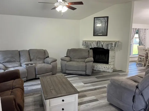 a living room with furniture and a fireplace