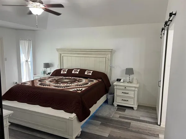 a bedroom with a bed and a chandelier