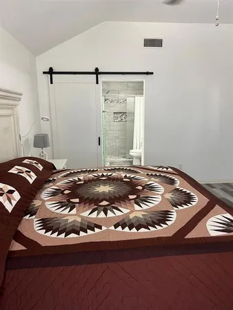 a bed sitting in a bedroom next to a window