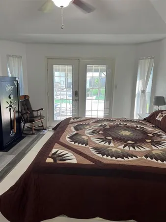 a bed sitting in a bedroom next to a window