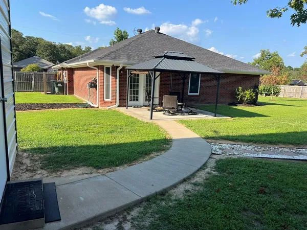a view of a house with a yard and plants