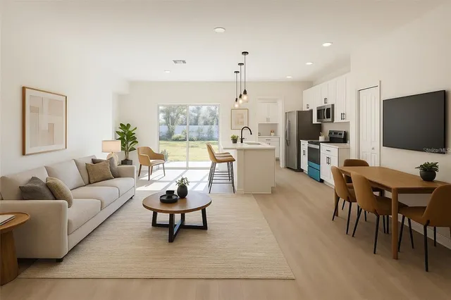 a utility room with wooden floor washer and dryer