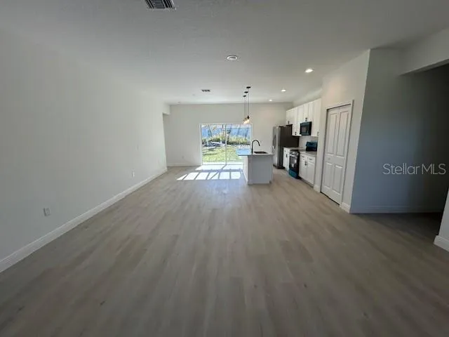a view of a kitchen with wooden floor