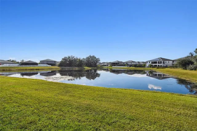 a view of a lake with houses in the background