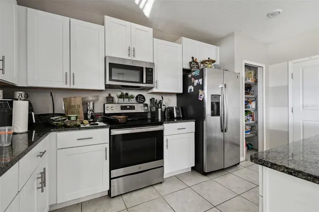 a kitchen with a sink cabinets and appliances