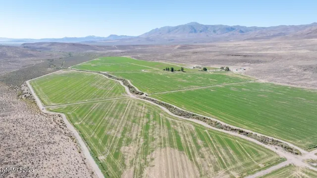 a view of a house with a yard and a lake view