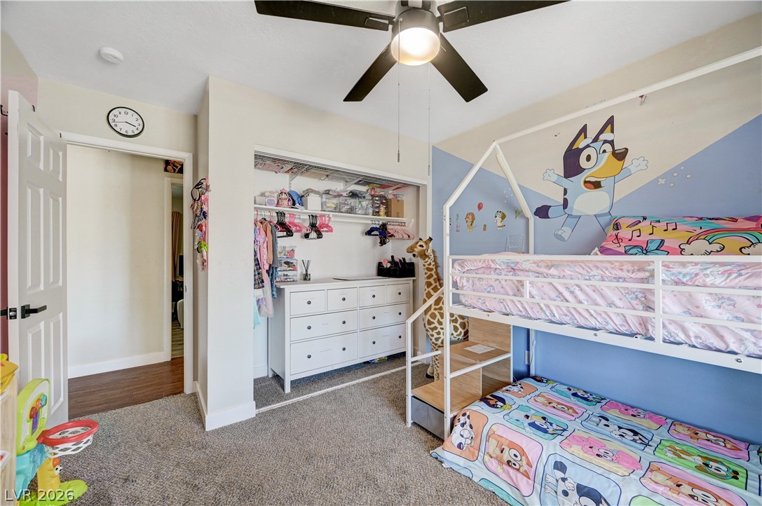 1331 Pinto Road Boulder City, NV 89005 - Photo 28 of 46 A cheerful children's bedroom features a built-in closet, cozy bunk beds, and a ceiling fan.