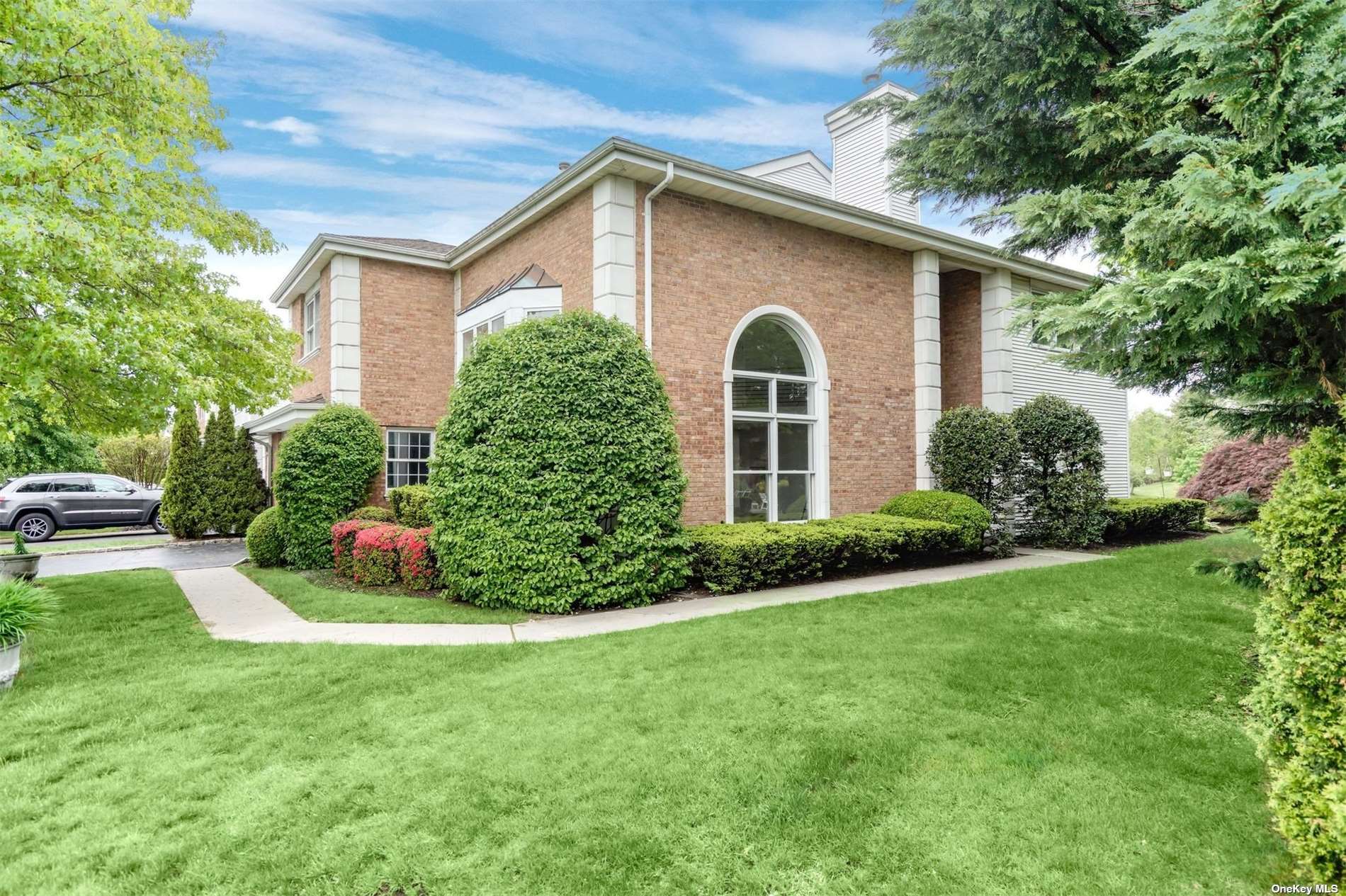 a front view of a house with a garden