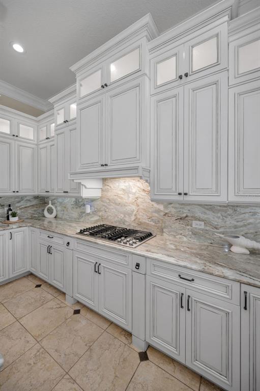 1227 Toscano Drive Trinity, FL 34655 - Photo 16 of 99 a kitchen with granite countertop white cabinets and stainless steel appliances