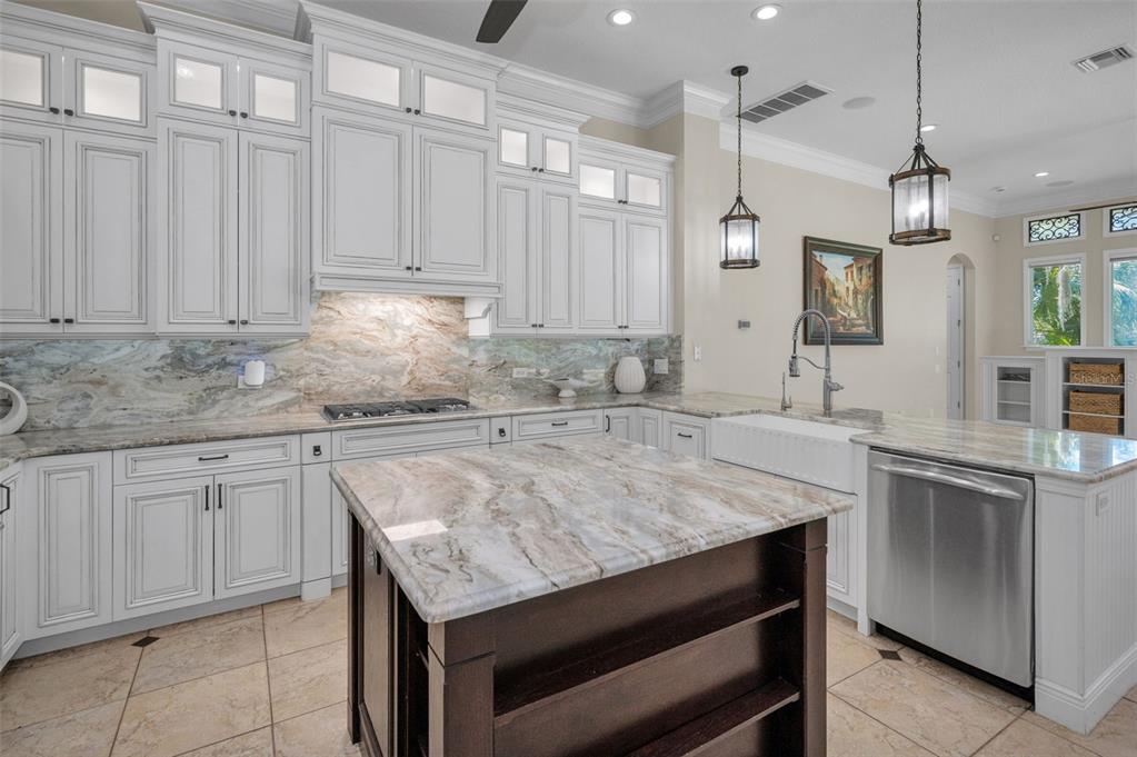 1227 Toscano Drive Trinity, FL 34655 - Photo 17 of 99 a kitchen with granite countertop a sink white cabinets and white appliances