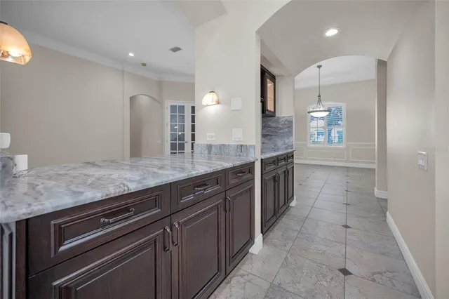 a view of staircase with lots of frames on wall and wooden floor