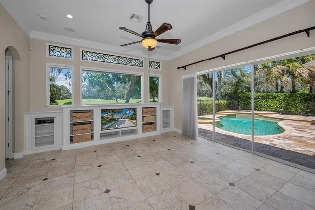 a view of a livingroom with a ceiling fan and window