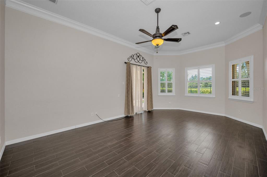 1227 Toscano Drive Trinity, FL 34655 - Photo 30 of 99 a view of an empty room with window and wooden floor
