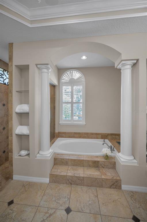 1227 Toscano Drive Trinity, FL 34655 - Photo 33 of 99 a spacious bathroom with a bathtub and window