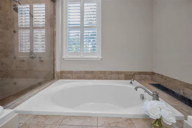 a view of a white house with a swimming pool and porch