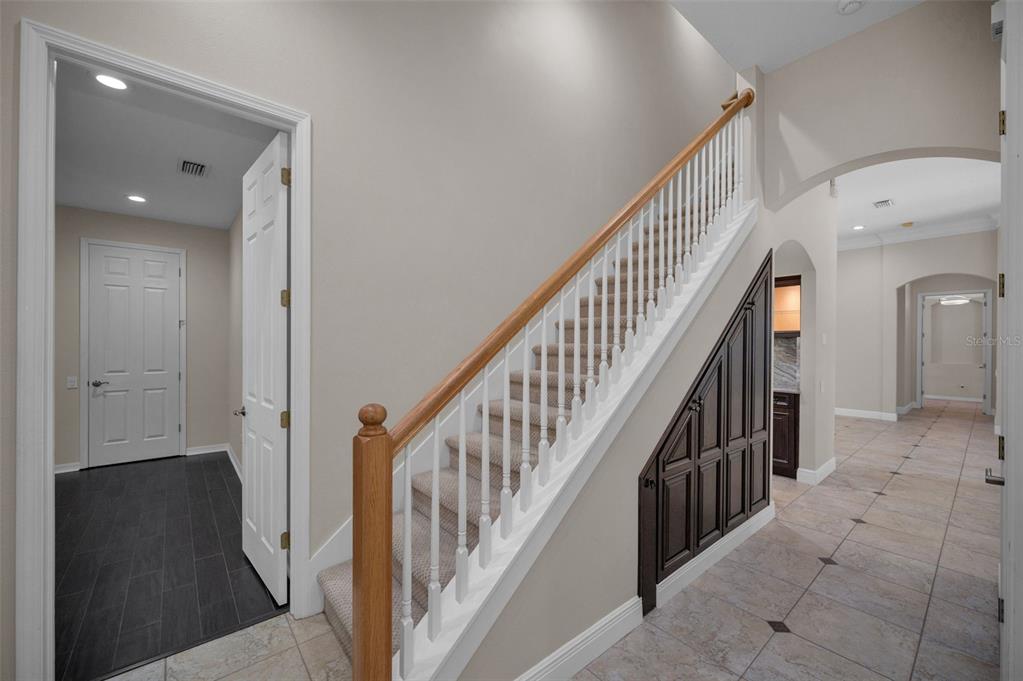 1227 Toscano Drive Trinity, FL 34655 - Photo 42 of 99 a view of staircase with lots of frames on wall and wooden floor