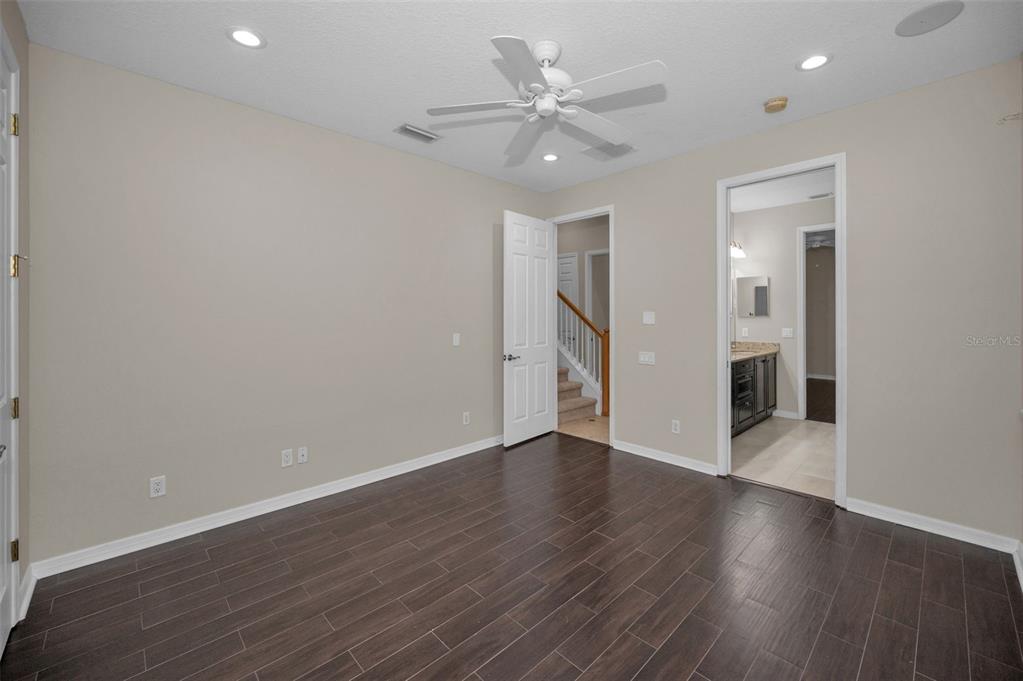 1227 Toscano Drive Trinity, FL 34655 - Photo 46 of 99 an empty room with wooden floor and a ceiling fan