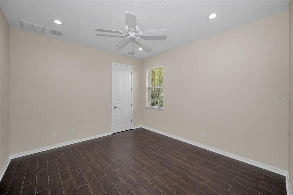 1227 Toscano Drive Trinity, FL 34655 - Photo 48 of 99 wooden floor in an empty room with a window