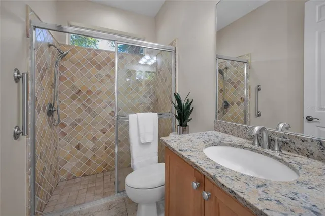 a living room with patio furniture and a floor to ceiling window
