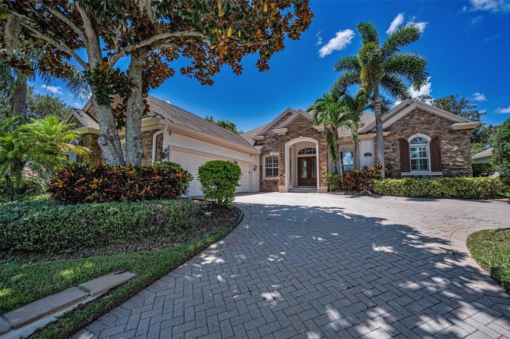 1227 Toscano Drive Trinity, FL 34655 - Photo 5 of 99 a front view of a house with a yard and potted plants