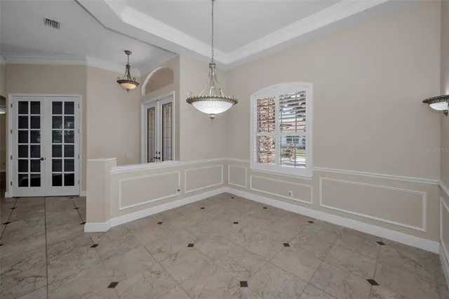 a kitchen with granite countertop a sink white cabinets and white appliances