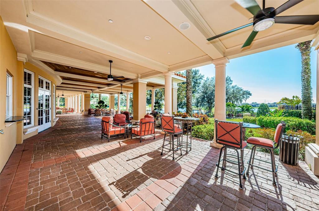 1227 Toscano Drive Trinity, FL 34655 - Photo 95 of 99 a living room with patio furniture and a floor to ceiling window