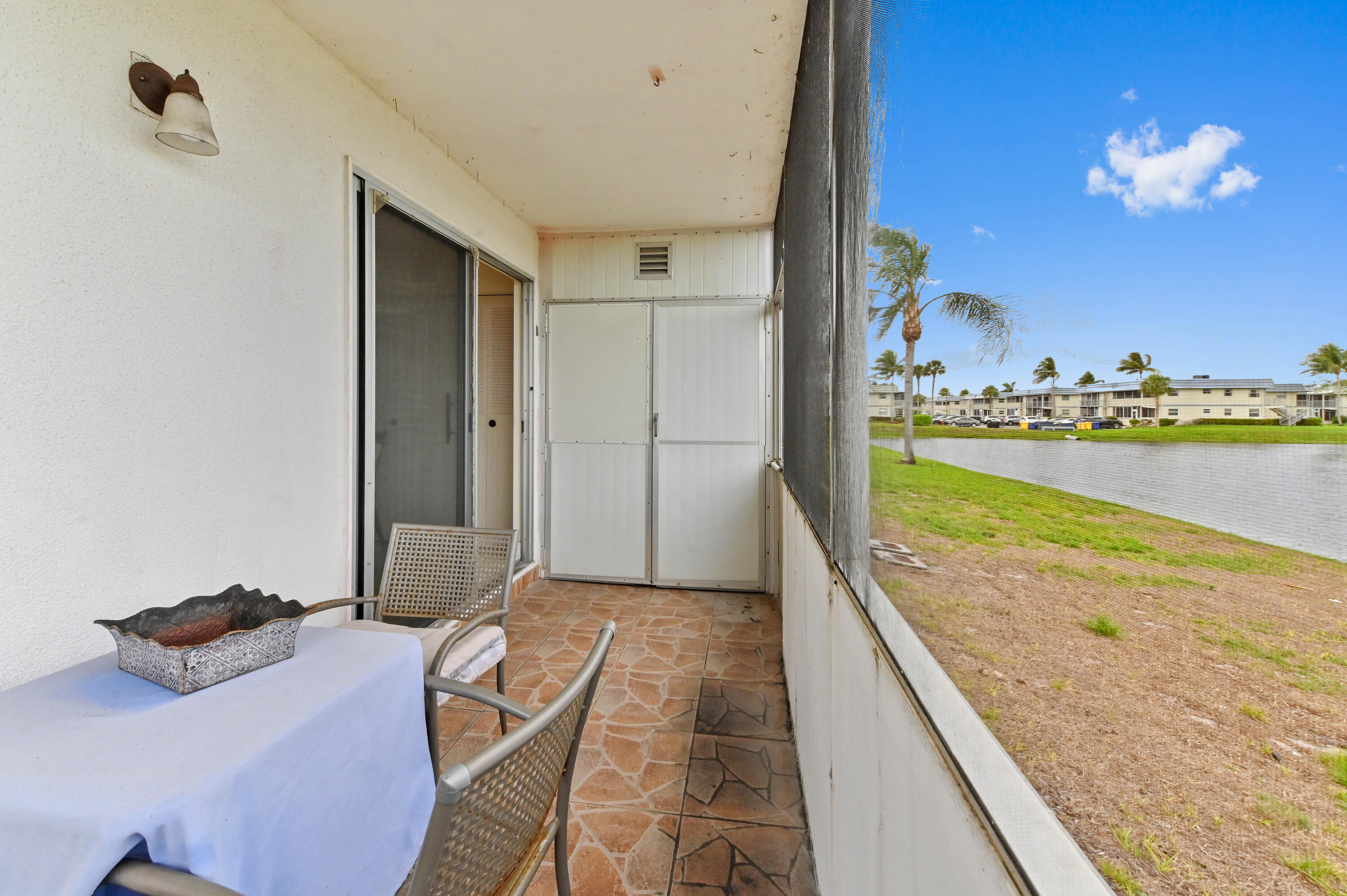 355 Monaco H Delray Beach Delray Beach, FL 33446 - Photo 13 of 30 a living room with dining table and a large window