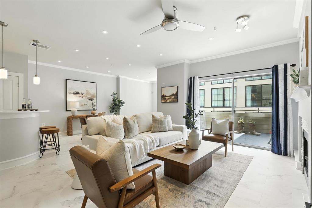 a living room with furniture and a glass door